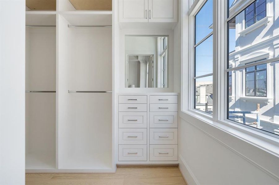 An oversize window in the closet allows for abundant natural light. (photo of interior model home with smaller floor plan)