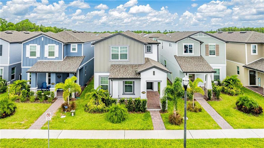 Front exterior of a new home in Encore at Ovation, Winter Garden, FL, highlighting curb appeal (Image 26).
