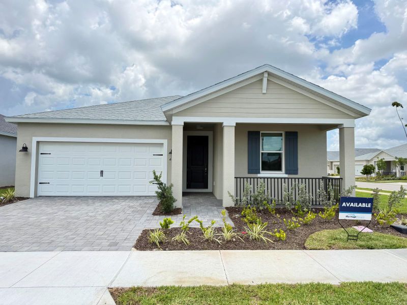 Front exterior of a new home in Crescent Lakes - Reserve Series, Punta Gorda, FL, highlighting curb appeal (Image 1). Front exterior of a new home in Crescent Lakes - Reserve Series, Punta Gorda, FL, highlighting curb appeal (Image 1).