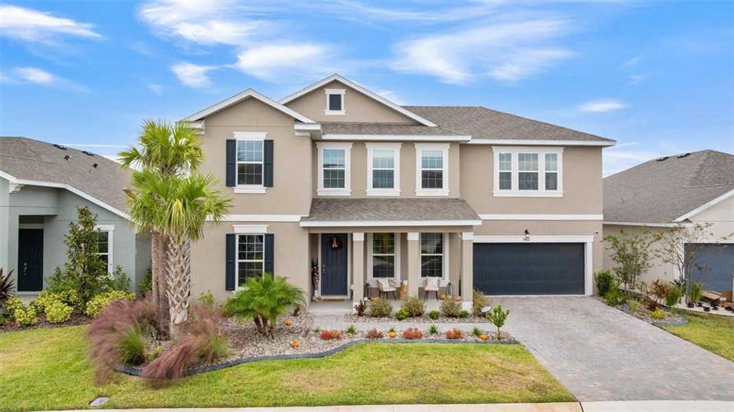 Front exterior of a new home in Seaire, Parrish, FL, highlighting curb appeal (Image 1).