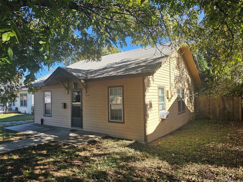 Bungalow-style house featuring cooling unit, a patio area, and a front lawn Bungalow-style house featuring cooling unit, a patio area, and a front lawn