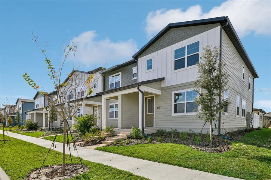 Front exterior of a new home in , Winter Garden, FL, highlighting curb appeal (Image 1).