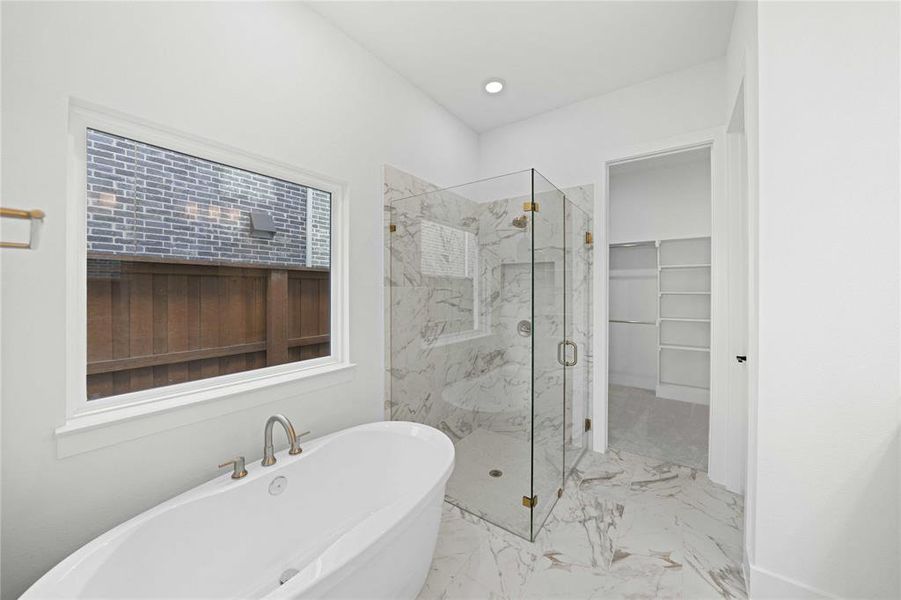 Full bath featuring a soaking tub, a marble finish shower, marble finish flooring, a walk in closet, and recessed lighting Full bath featuring a soaking tub, a marble finish shower, marble finish flooring, a walk in closet, and recessed lighting