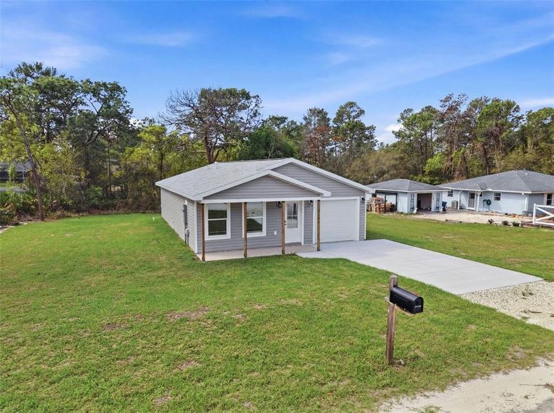 Front exterior of a new home in , Weeki Wachee, FL, highlighting curb appeal (Image 30).