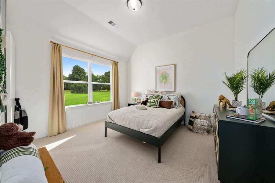 Bedroom featuring lofted ceiling and light wood-type flooring