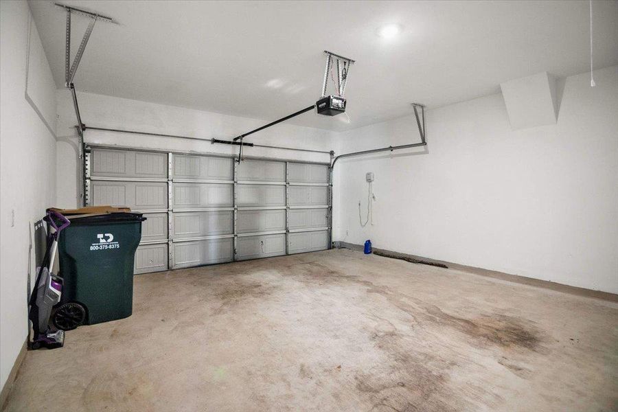 A spacious, clean garage provides ample room for parking and storage.