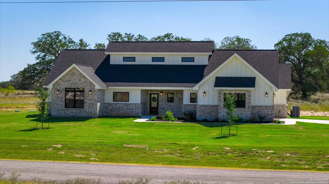 Front exterior of a new home in , Floresville, TX, highlighting curb appeal (Image 1). Front exterior of a new home in , Floresville, TX, highlighting curb appeal (Image 1).