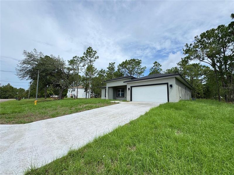 Front exterior of a new home in , Citrus Springs, FL, highlighting curb appeal (Image 27).