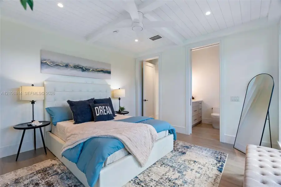 Beadboard ceiling with crown molding, recessed lighting, and a central ceiling fan, featuring porcelain-finish flooring and a multi-panel door Beadboard ceiling with crown molding, recessed lighting, and a central ceiling fan, featuring porcelain-finish flooring and a multi-panel door