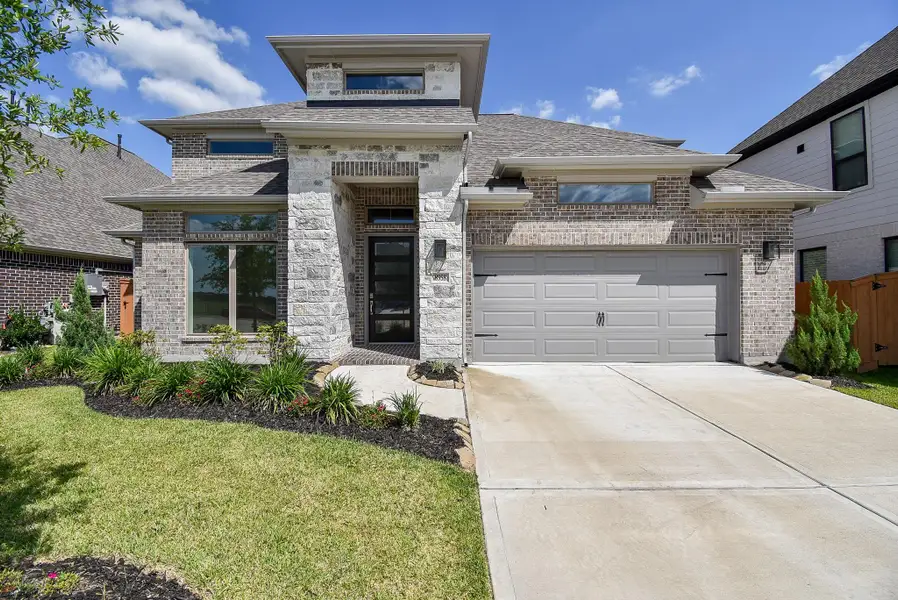 Front exterior of a new home in Marvida, Cypress, TX, highlighting curb appeal (Image 2).