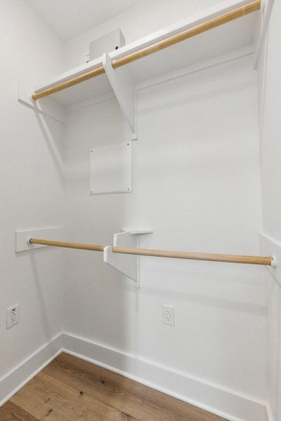 Walk in closet featuring wood finished floors Walk in closet featuring wood finished floors