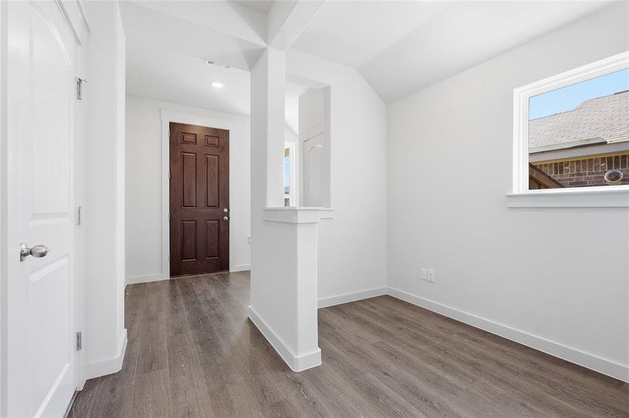 Foyer entrance featuring lofted ceiling, dark wood-style floors, and recessed lighting