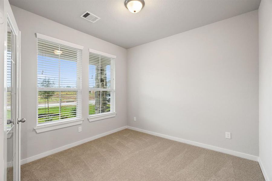 Inviting home office, featuring premium soft carpet that adds a touch of freshness and comfort to the workspace. Sample photo of completed home with similar floor plan. As-built interior colors and selections may vary.