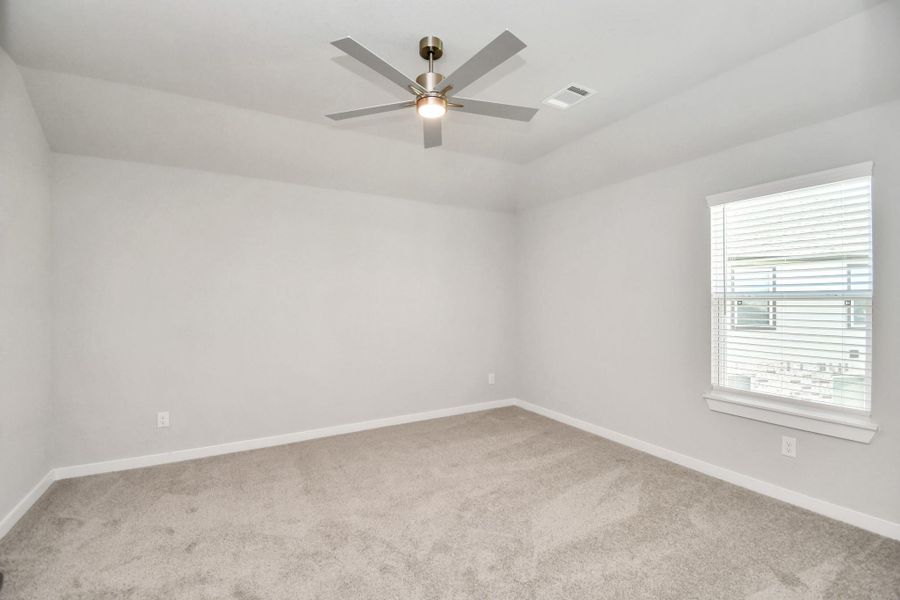 Secondary bedroom features plush carpeting, large windows that let in plenty of natural light, bright paint, and spacious closets. Sample photo of completed home with similar floor plan. Actual colors and selections may vary. Secondary bedroom features plush carpeting, large windows that let in plenty of natural light, bright paint, and spacious closets. Sample photo of completed home with similar floor plan. Actual colors and selections may vary.