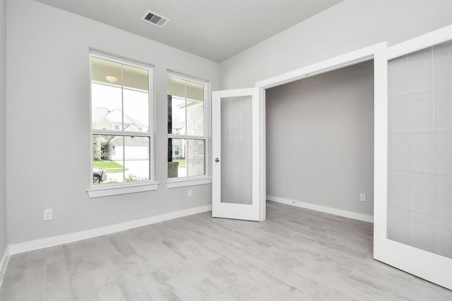 Step into this inviting home office, adorned with premium tile flooring that infuses a sense of freshness and comfort into the workspace. Bask in the natural light pouring through the window, fostering an inspiring environment ideal for productivity and focused work. Sample photo of completed home with similar floor plan. Actual colors and selections may vary.