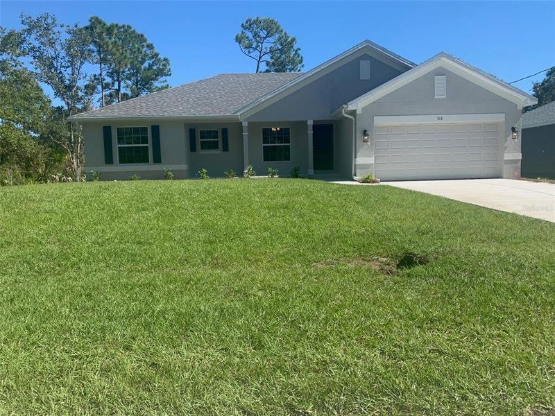 Front exterior of a new home in Port Charlotte, Port Charlotte, FL, highlighting curb appeal (Image 1).