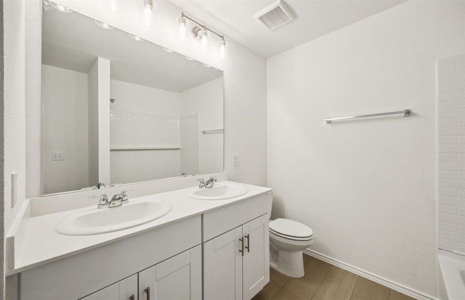 Elegant owner's bathroom with dual vanity
