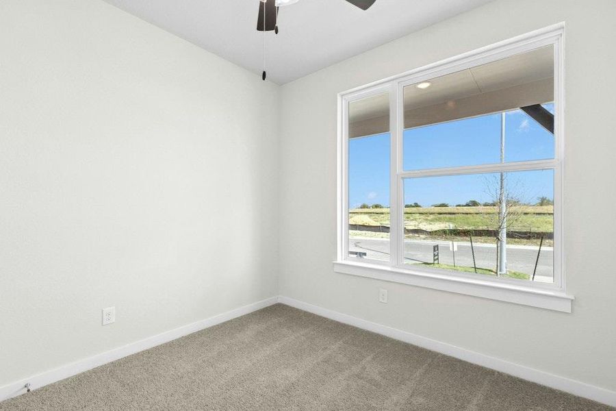 Spare room with carpet floors and a ceiling fan