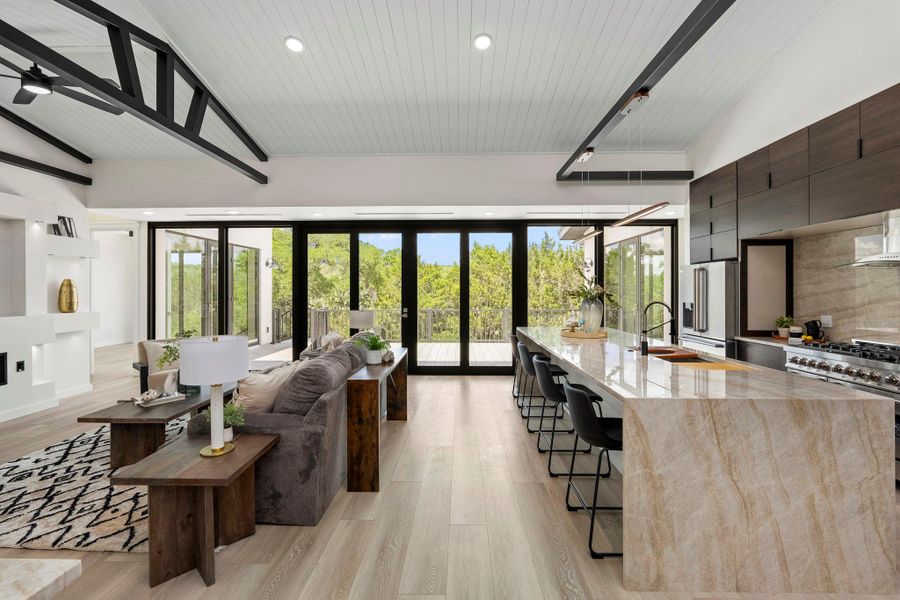 Living room with light wood-style floors, healthy amount of natural light, recessed lighting, a vaulted wood ceiling, and french doors