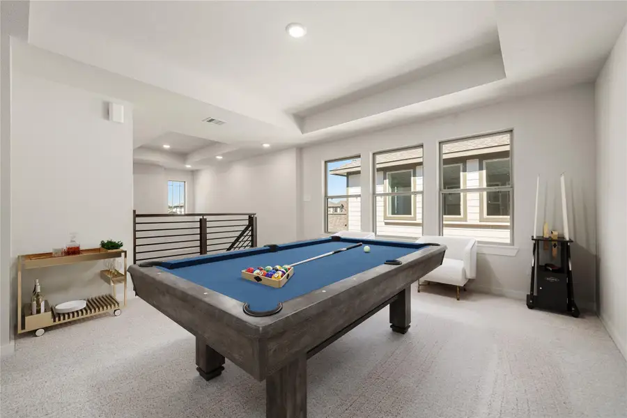 An inviting upstairs loft with plenty of natural light, offering a flexible space that can be used as a game room, media area, or home office. An inviting upstairs loft with plenty of natural light, offering a flexible space that can be used as a game room, media area, or home office.