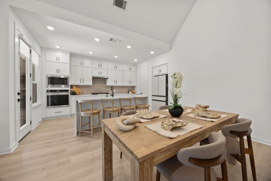 Dining space featuring recessed lighting and light wood-style floors