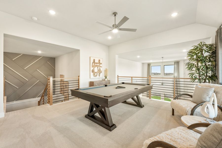 Open loft game room with pool table, ceiling fan, and metal railing overlooking lower floor