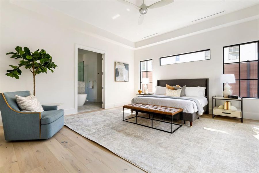 Bedroom with wood-type flooring, ceiling fan, and ensuite bathroom Bedroom with wood-type flooring, ceiling fan, and ensuite bathroom