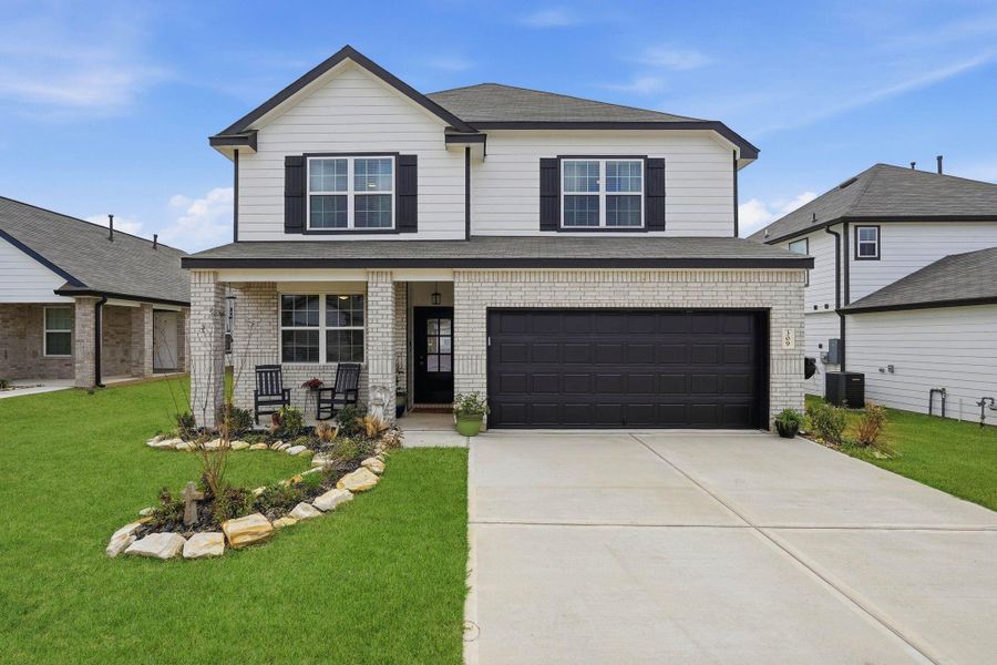 Front exterior of a new home in Hunter's Creek, Huntsville, TX, highlighting curb appeal (Image 20).