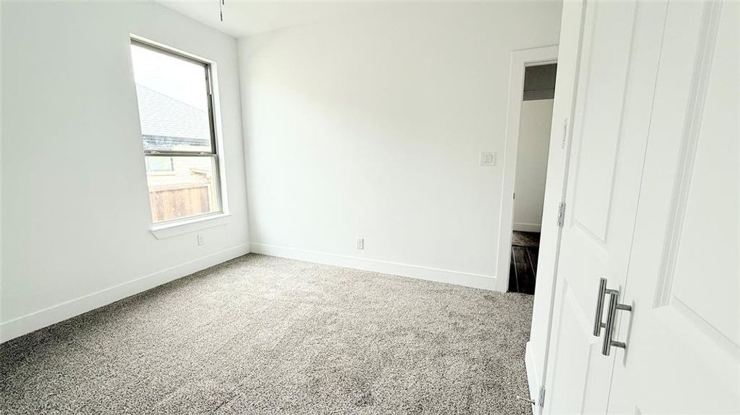 Bedroom featuring baseboards and carpet floors