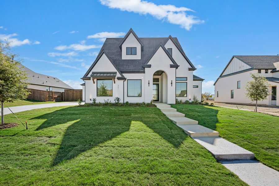 Front exterior of a new home in NorthGlen, Haslet, TX, highlighting curb appeal (Image 1).