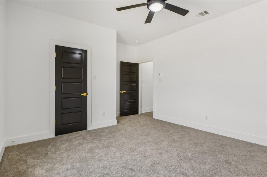 Unfurnished bedroom featuring carpet floors and ceiling fan Unfurnished bedroom featuring carpet floors and ceiling fan