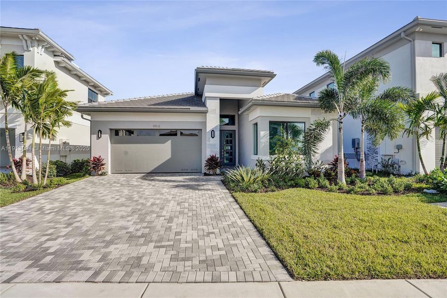 Front exterior of a new home in Apex at Avenir, Palm Beach Gardens, FL, highlighting curb appeal (Image 26).