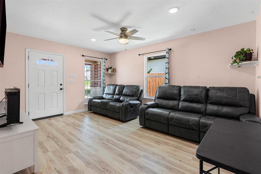 Living room featuring light wood-type flooring, recessed lighting, and ceiling fan Living room featuring light wood-type flooring, recessed lighting, and ceiling fan