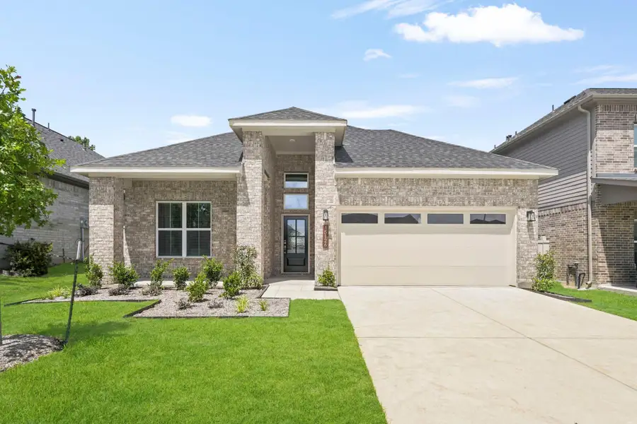 Front exterior of a new home in Audubon, Magnolia, TX, highlighting curb appeal (Image 1). Front exterior of a new home in Audubon, Magnolia, TX, highlighting curb appeal (Image 1).