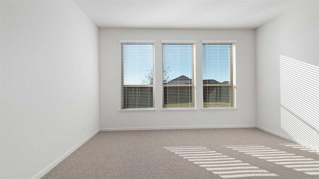 Empty room with light colored carpet and plenty of natural light