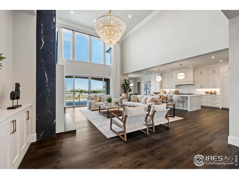 Stunning main living area iconic light fixtures controlled by Lutron Lighting System, 7" White Oak flooring, and double height floor to ceiling windows