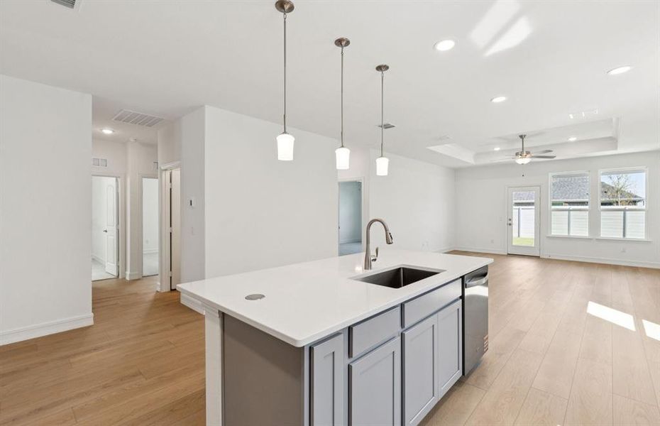 Large island overlooking gathering room and dining areas