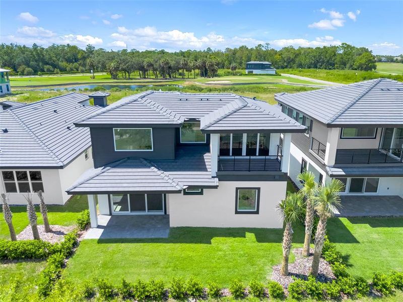 Exterior details and patio area of a home in Hampton Green at Providence, Davenport (Image 38).