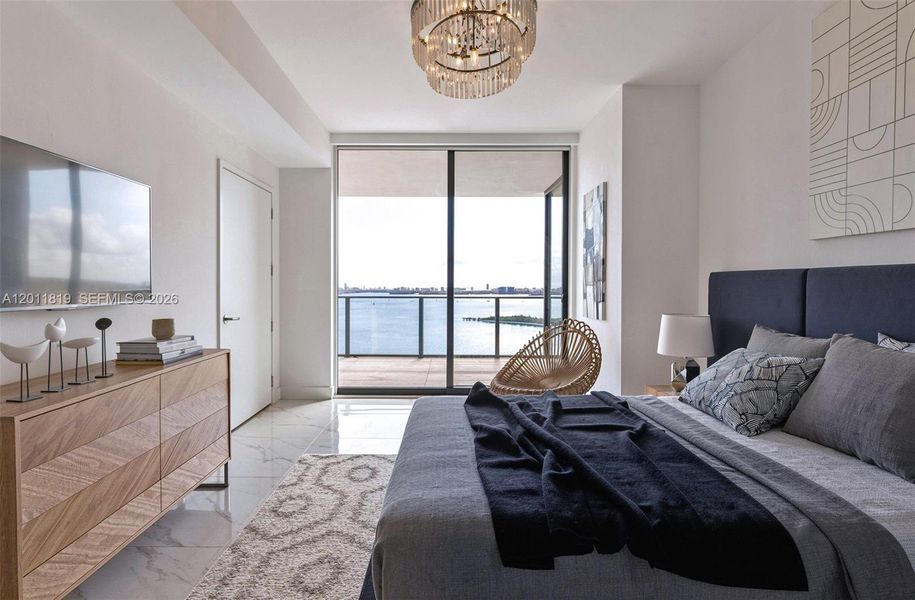 Serene primary suite offering unobstructed water views, direct terrace access, oversized walk-in closets, and floor-to-ceiling windows for a true 'mansion in the sky' feel. Image is virtually staged.