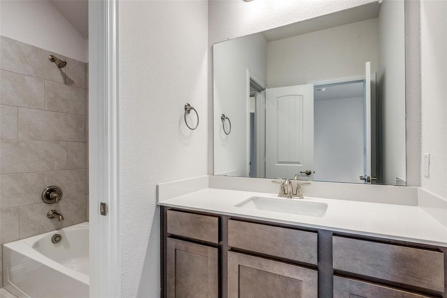 Full bath with vanity and bathtub / shower combination