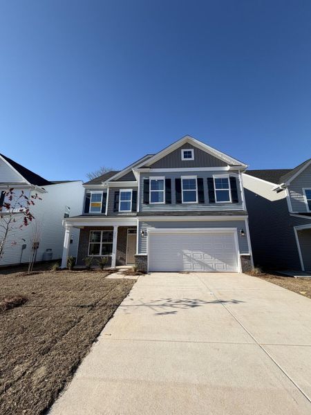 Front exterior of a new home in Parker's Preserve, Ridgeville, SC, highlighting curb appeal (Image 2). Front exterior of a new home in Parker's Preserve, Ridgeville, SC, highlighting curb appeal (Image 2).