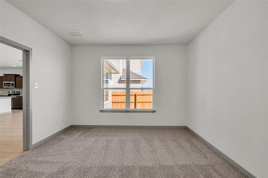 Spare room with light colored carpet and baseboards