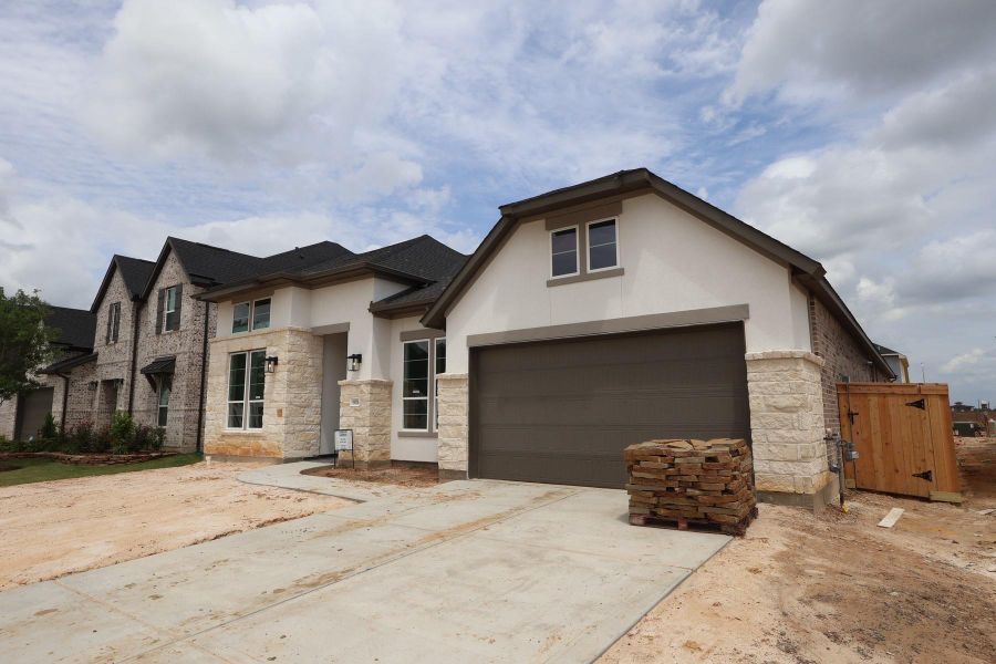 Front exterior of a new home in Dunham Pointe, Cypress, TX, highlighting curb appeal (Image 2). Front exterior of a new home in Dunham Pointe, Cypress, TX, highlighting curb appeal (Image 2).