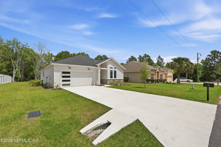 Front exterior of a new home in Palm Coast Homes, Palm Coast, FL, highlighting curb appeal (Image 27).