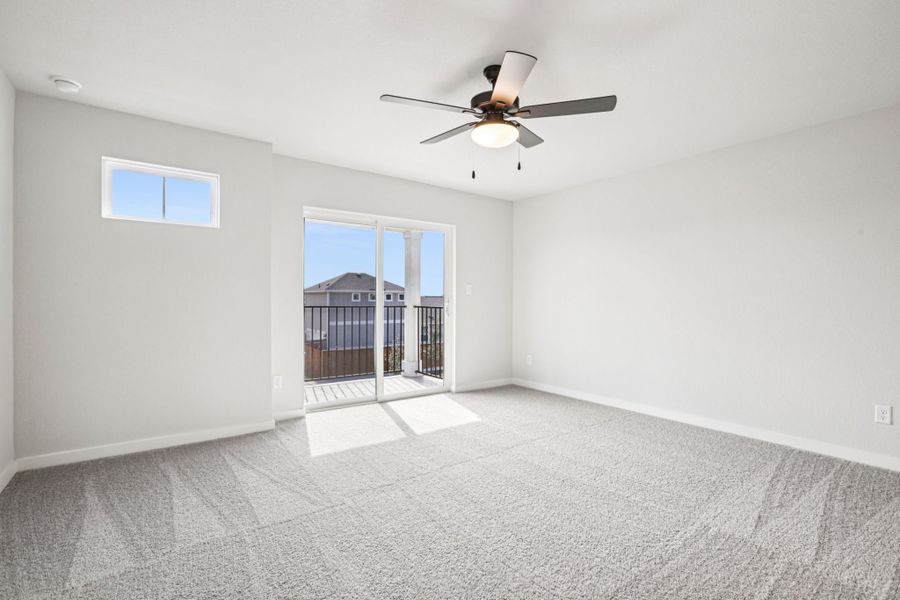 A room with a ceiling fan and a window.