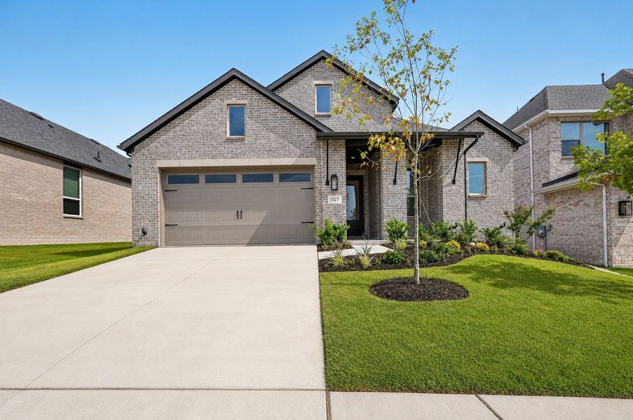 Front exterior of a new home in Monterra, Fate, TX, highlighting curb appeal (Image 1). Front exterior of a new home in Monterra, Fate, TX, highlighting curb appeal (Image 1).