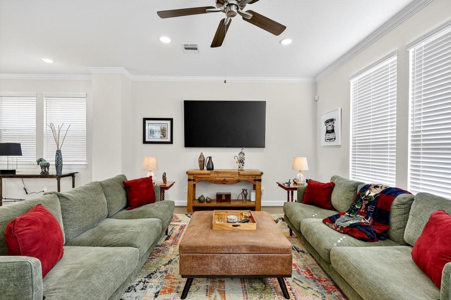 Comfortable living area with recessed lighting and ceiling fan for added comfort. Comfortable living area with recessed lighting and ceiling fan for added comfort.