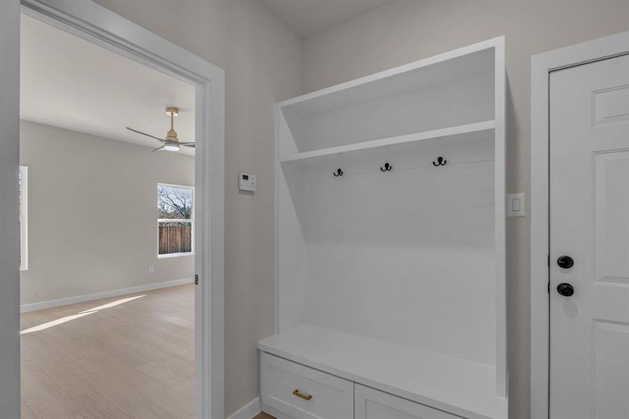 Mudroom with ceiling fan and light wood-type flooring