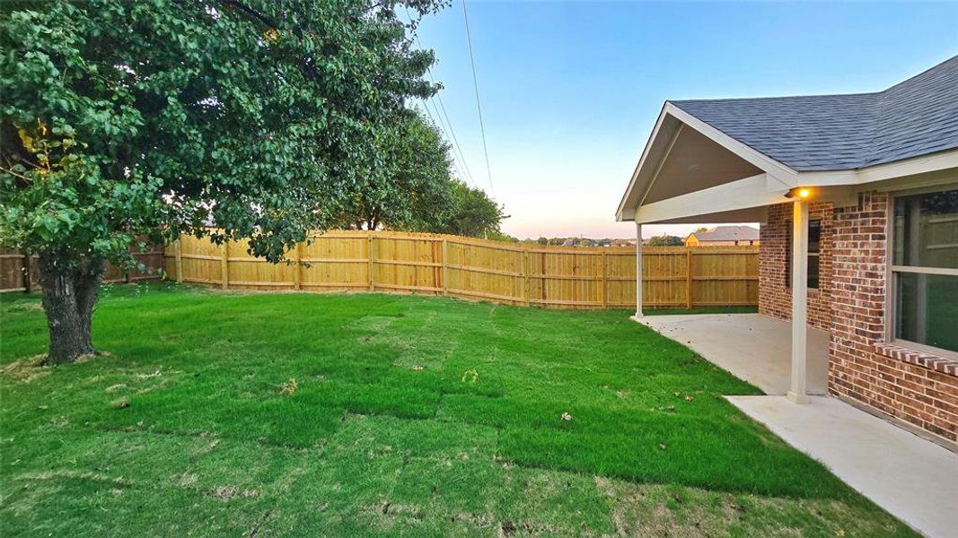 Fenced backyard with a patio