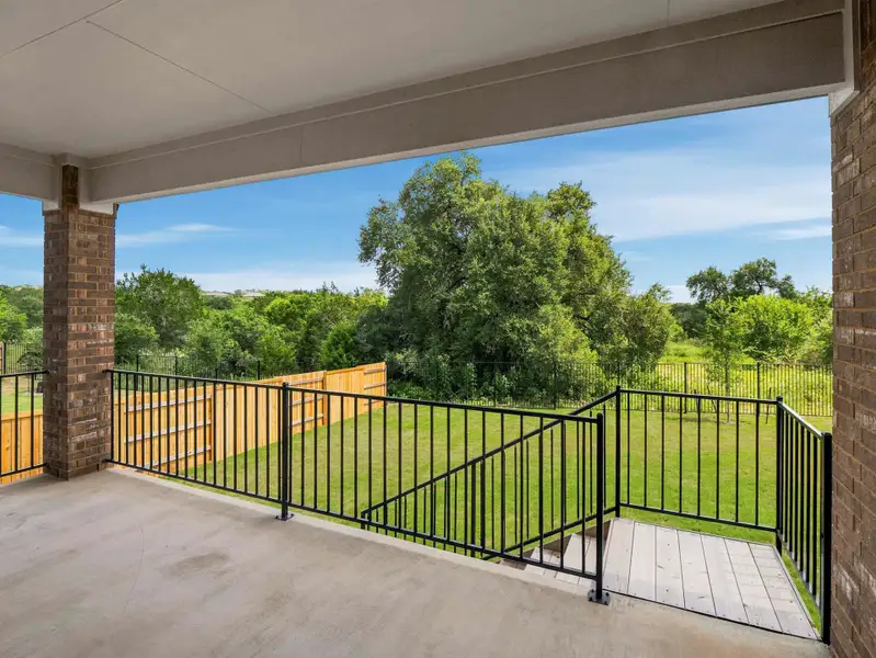An inviting covered patio offers a private outdoor retreat with a verdant view. An inviting covered patio offers a private outdoor retreat with a verdant view.